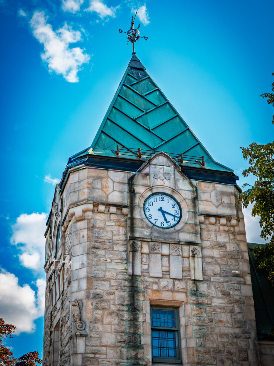 Historic Westport Ontario post office clock tower with green roof and flower planters